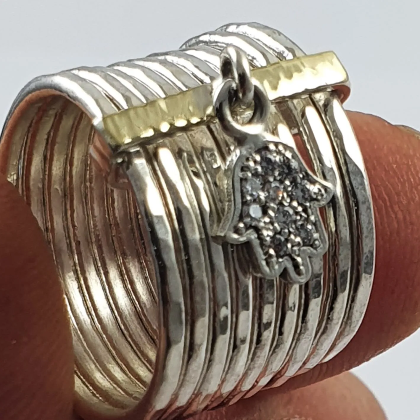 Spinner ring with a hamsa charm sterling silver and gold